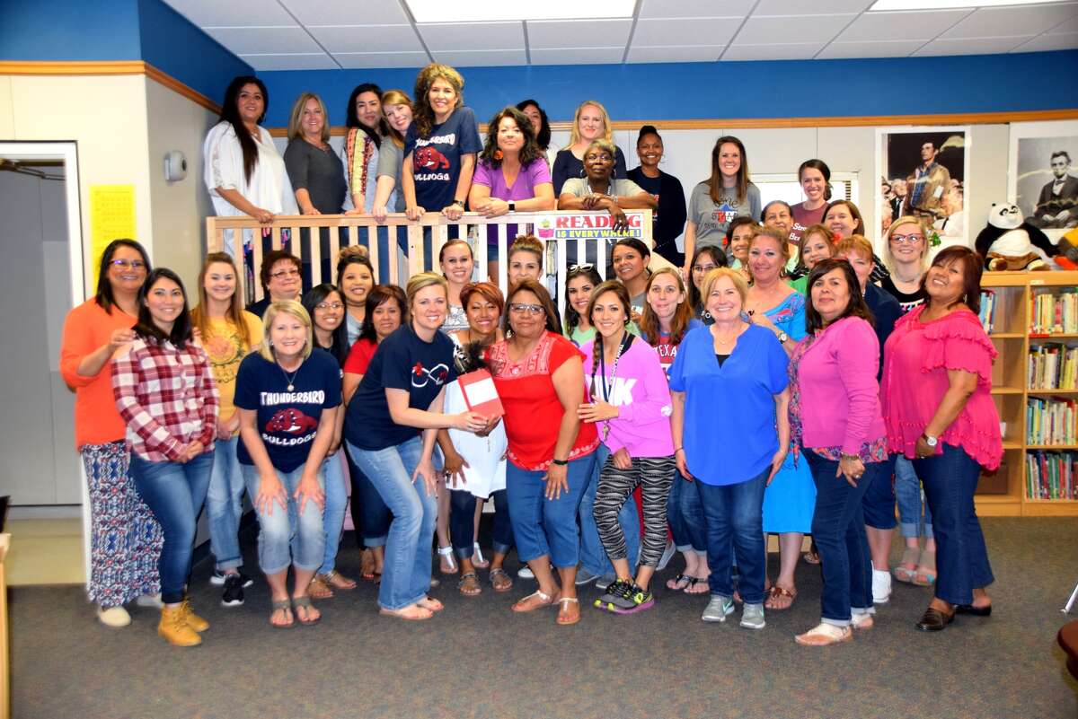 Thunderbird assistant Ana Landeros (front row, fourth from left) is completing 35 years of service to Plainview Independent School District. She is pictured surrounded by other members of the Thunderbird staff who gathered to congratulate her.