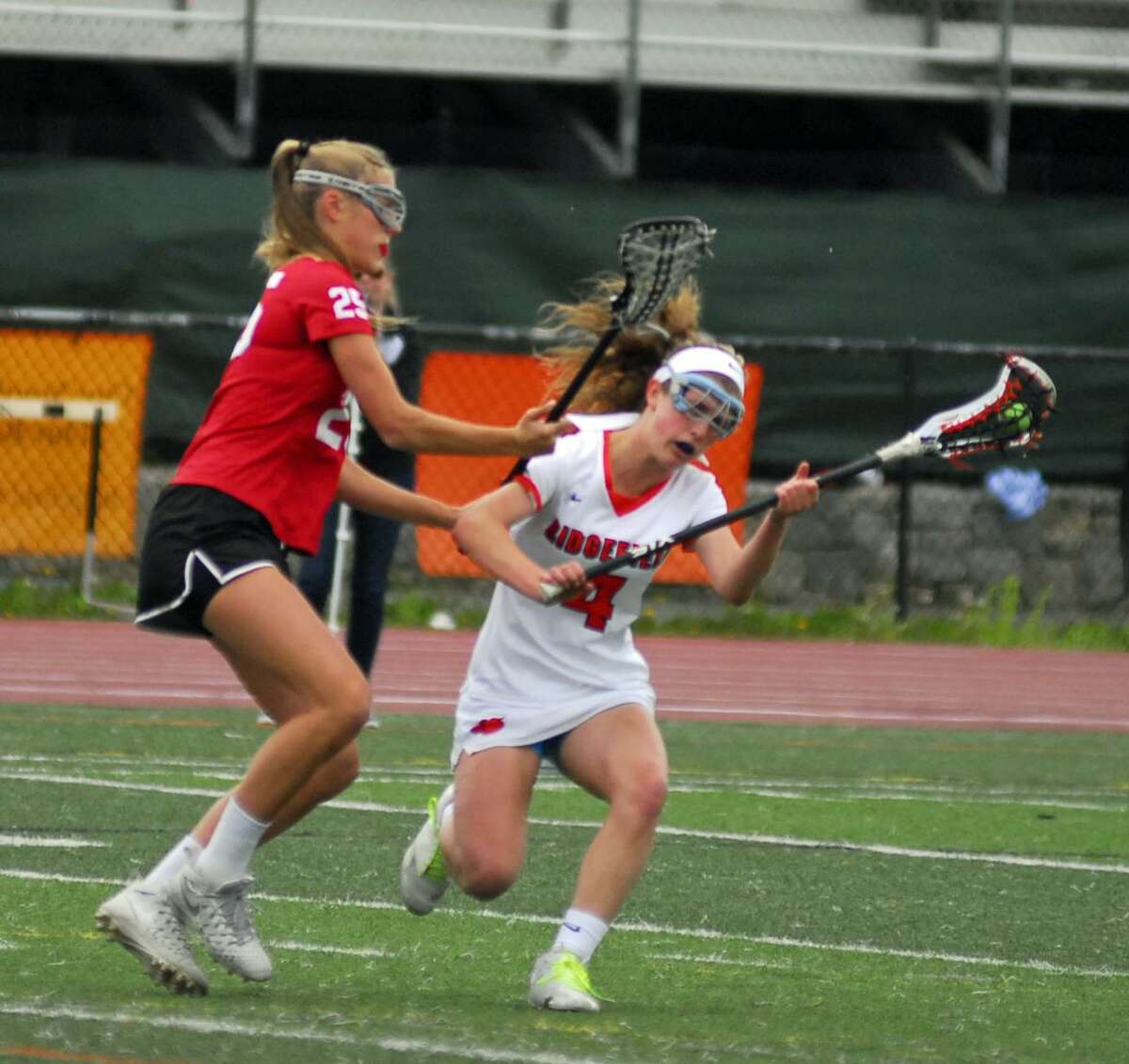 Action from New Canaan's 16-10 win over Ridgefield on Tuesday.