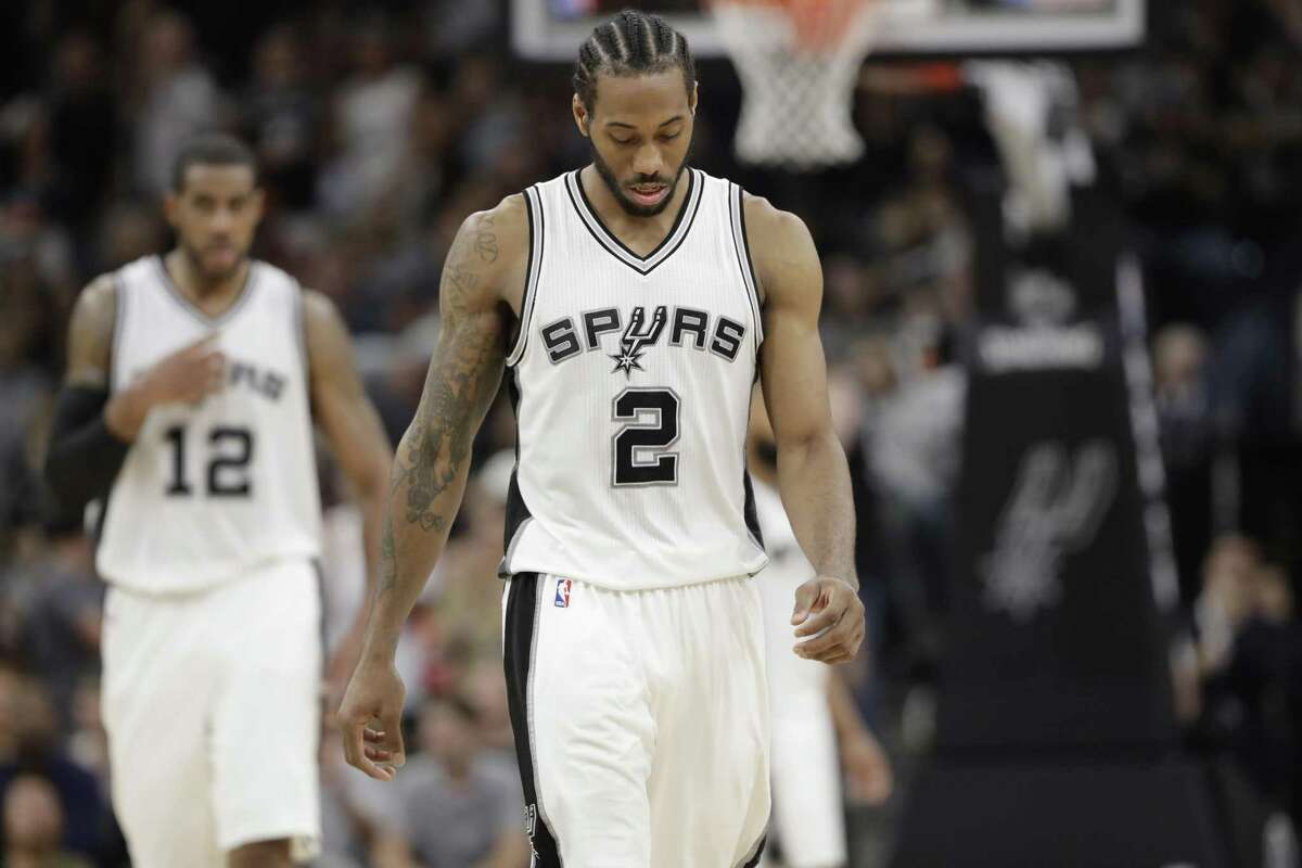 Spurs forward Kawhi Leonard (2) and forward LaMarcus Aldridge walk up the court during the second half of Game 5 against the Rockets on May 9, 2017, in San Antonio.