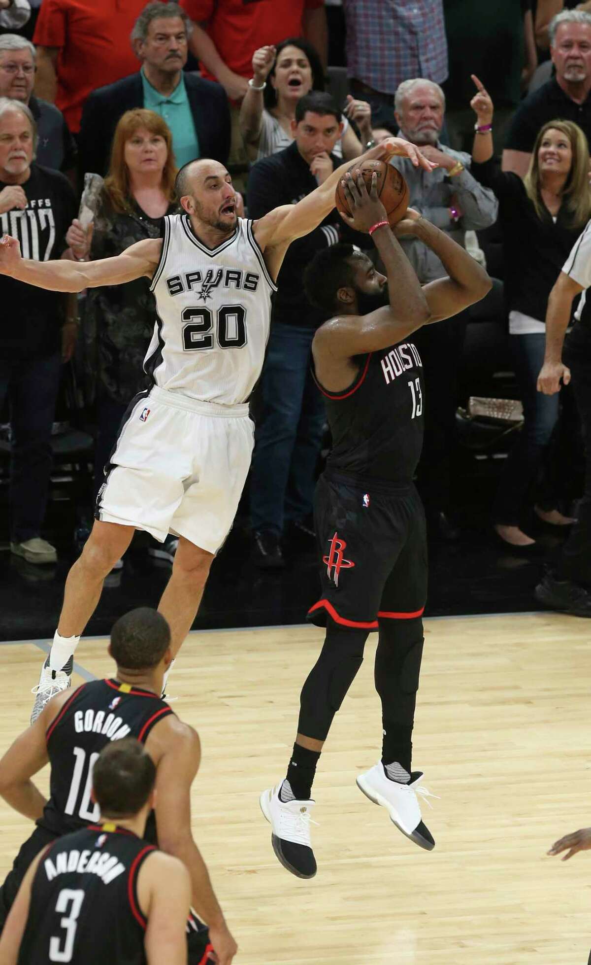 San Antonio Spurs’ Manu Ginobili blocks Houston Rockets’ James Harden at the end of overtime in the Western Conference semifinals at the AT&T Center, Tuesday, May 9, 2017. The Spurs won in overtime 110-107 to go up in the series, 3-2.