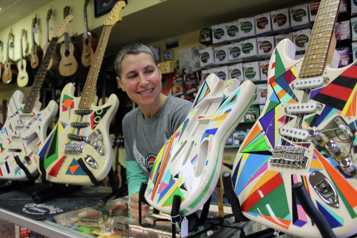 Julie Rosenberg, with her painted guitars at New Canaan Music on May 4, 2017.