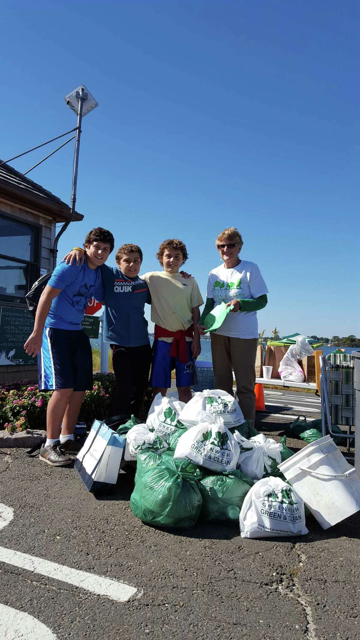 Eastern Middle School students, (l-r) Ryan Djurkovic, Kyle Goeller and Tristan Goeller with Greenwich Green & Clean volunteer Renie Schmidt assist in tallying trash items picked up during the fall town-wide cleanup.