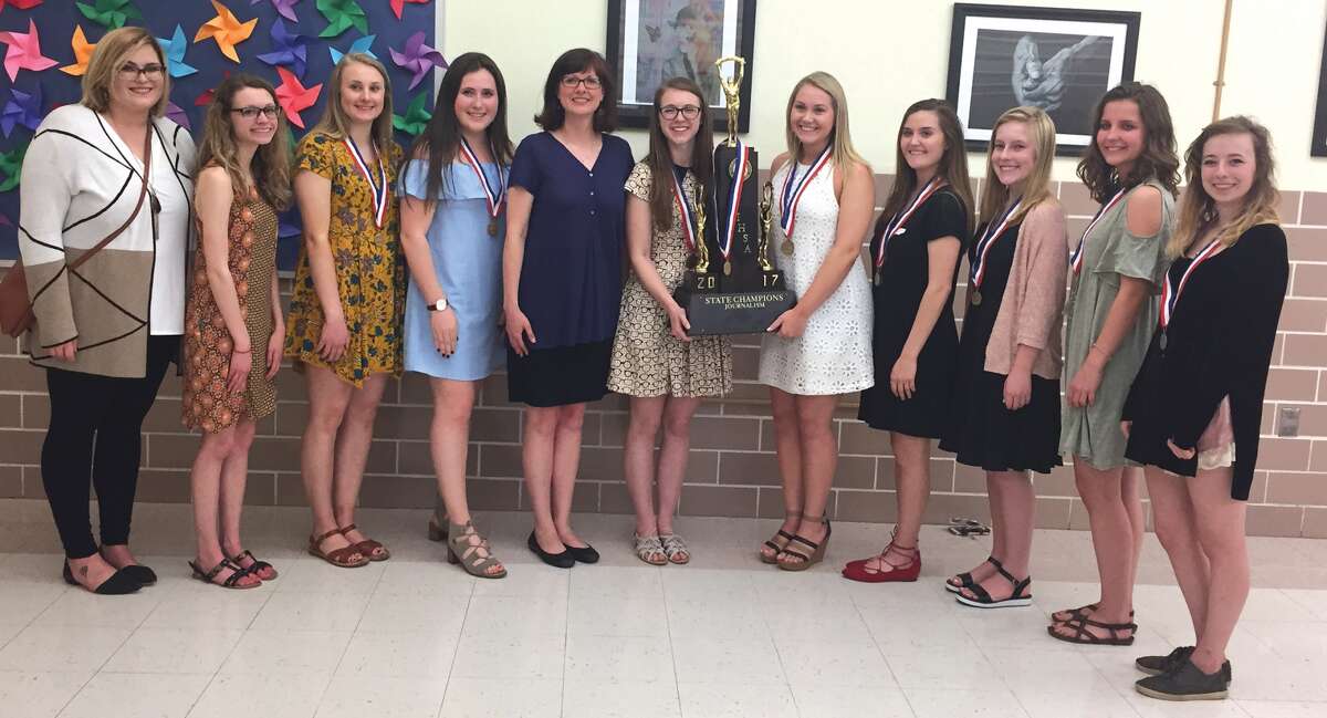 Co-advisor Lauren Mudge left and Edwardsville High School journalistm teacher Amanda Thrun, fifth from left, stand with the EHS journalism students who recently tied for first place in the state competition at Eastern Illinois University.