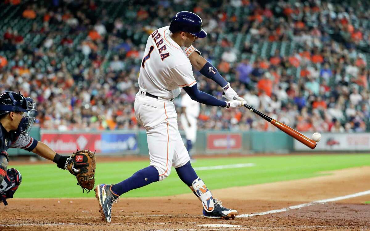 Houston Astros' Carlos Correa (1) hits a two-run double as Atlanta Braves catcher Kurt Suzuki works behind the plate during the fifth inning of a baseball game Wednesday, May 10, 2017, in Houston. (AP Photo/David J. Phillip)