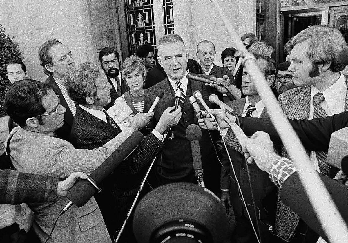 Special Watergate prosecutor Archibald Cox is surrounded by newsmen outside D.C. District Court in Washington on Friday, Oct. 19, 1973, after ousted White House counsel John W. Dean III pleaded guilty to conspiring to obstruct the Watergate investigation. Cox said he further charges would be brought with the exception of perjury if Dean's testimony proves false. (AP Photo)