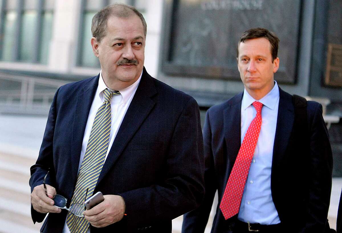 FILE - In a Tuesday, Nov. 24, 2015, file photo, former Massey Energy CEO Don Blankenship, left, walks out of the Robert C. Byrd U.S. Courthouse after the jury deliberated for a fifth full day in his trial, in Charleston, W. Va. Blankenship is finishing up his one-year federal prison sentence related to the deadliest U.S. mine explosion in four decades. According to the U.S. Bureau of Prisons website, Blankenship is set to be released Wednesday, May 10, 2017, from a halfway house in Phoenix. He must serve one year of supervised release. (AP Photo/Chris Tilley, File)