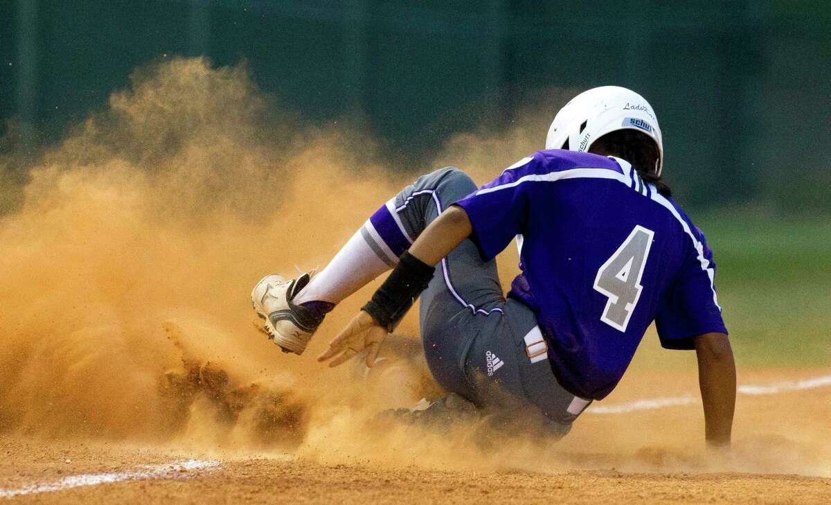 Lily Atkinson #4 of Willis slides into second after beating the throw to Bryan third baseman Rachel Agnello (8) during the fourth inning in Game 1 of a Region III-5A quarterfinal series Wednesday, May 10, 2017, in Montgomery.
