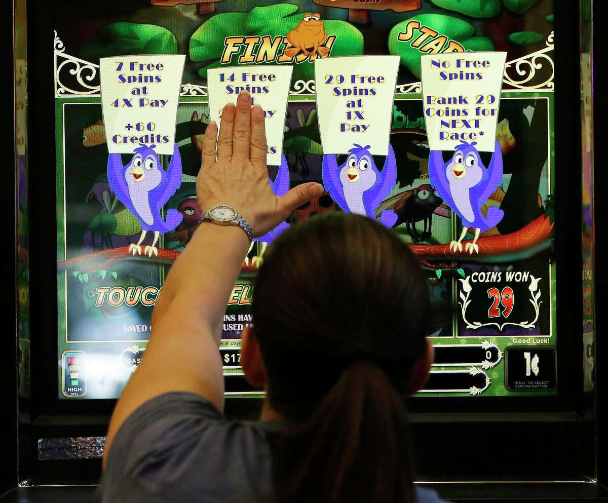 A gamer selects her options on a machine at Naskila Entertainment in Livingston, Texas on Tuesday, June 7, 2016. The Alabama Coushatta Indian Tribe in Livingston - about an hour north of Houston - reopened its casino after a 14-year closure prompted by threats from the state of Texas to take legal action against the tribe. Recent legal developments paved the way for the reopening. With 365 Class 2 electronic gaming devices, the former casino has been renamed Naskila Entertainment and its doors opened earlier this month to eager guests and gamers. Only "bingo" type machines are in use at Naskila Entertainment according to officials. (Kin Man Hui/San Antonio Express-News)