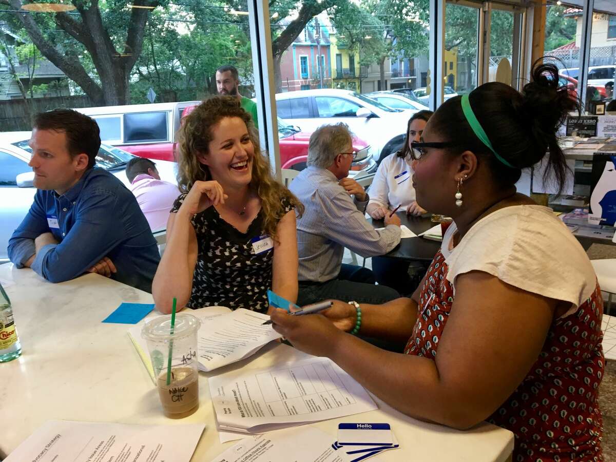 Jessica Wilbanks (center) talks with one of the participants at Activist Office Hours, organized by a group of Houston-based political activists called Preparing for Action.