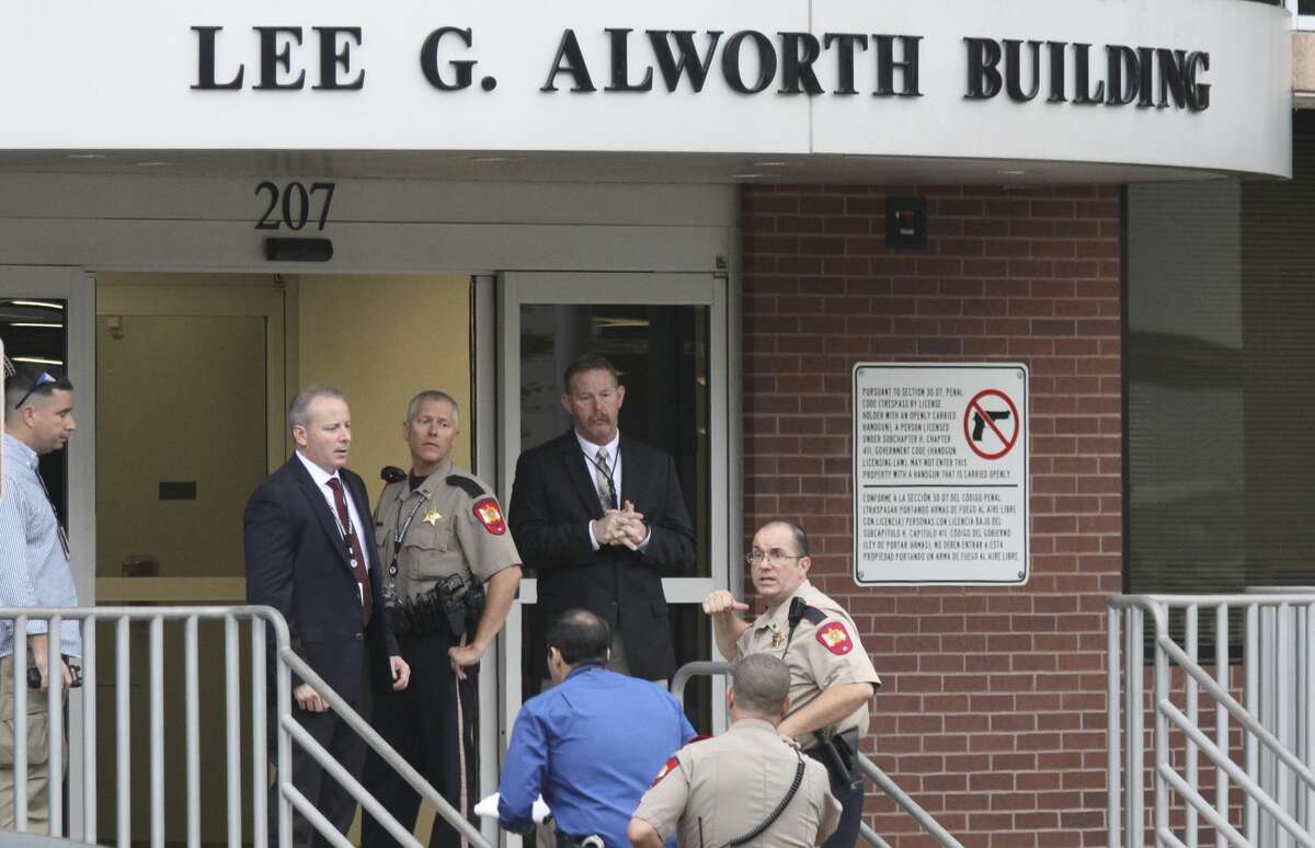Law enforcement are seen outside the Lee G. Alworth Building after a bomb threat was made to the 221 state District Court, located inside the Alworth building in downtown Conroe, Wednesday, May 11, 2017.