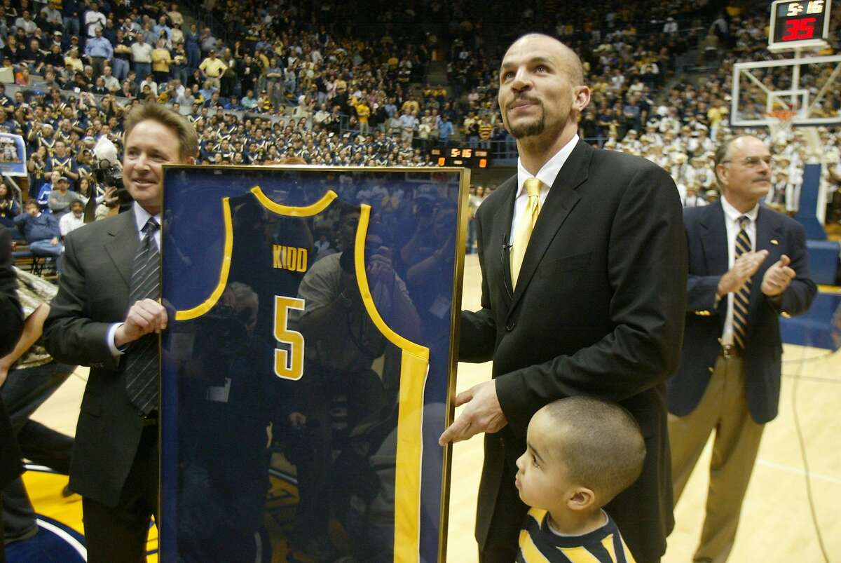 Event at Berkeley on 2/14/04. Former Cal player Jason Kidd accepts his former jersey, which is being retired at cal. Cal's current coach Ben Braun is on the left. Jason's son is next to him (I do not know his name.) Cal bears play the Stanford Cardinals at Berkeley. Liz Mangelsdorf/ The Chronicle Jason Kidd (right), assisted by Cal coach Ben Braun, shows off his retired jersey. ProductNameChronicle