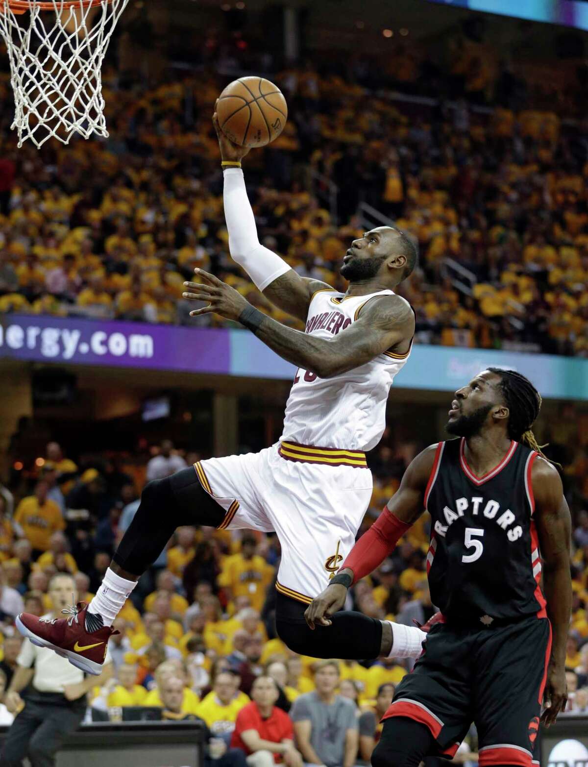 FILE - In this May 1, 2017, file photo, Cleveland Cavaliers' LeBron James (23) drives past Toronto Raptors' DeMarre Carroll (5) in the first half in Game 1 of a second-round NBA basketball playoff series, in Cleveland. Kevin Durant looks at LeBron James from afar and marvels at how the Cavs main man keeps finding a way to take his game to another level, year after year.(AP Photo/Tony Dejak, File)