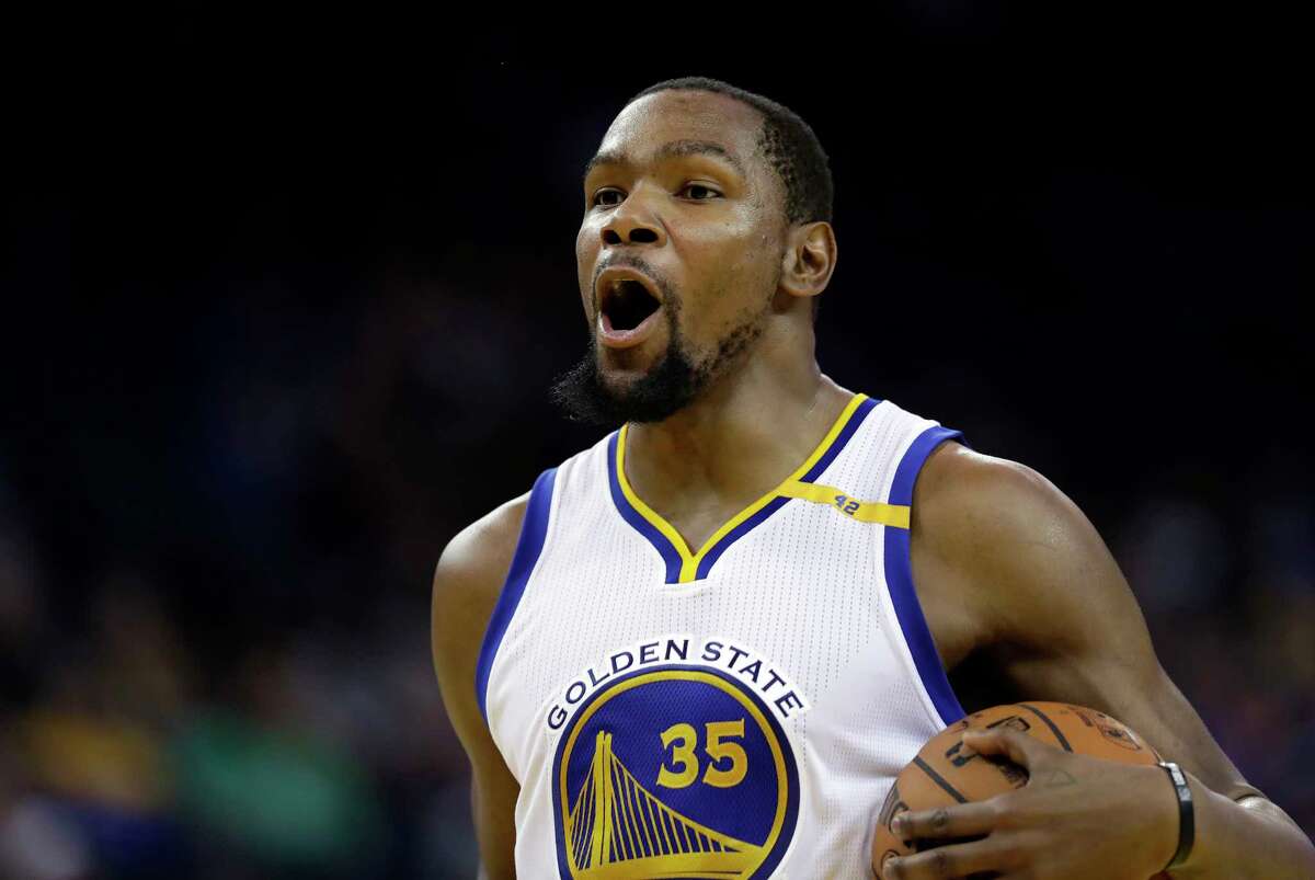 FILE - In this Jan. 10, 2017, file photo, Golden State Warriors' Kevin Durant (35) reacts after a foul called against him during the second half of the team's NBA basketball game against the Miami Heat, in Oakland, Calif. Durant looks at LeBron James from afar and marvels at how the Cavs main man keeps finding a way to take his game to another level, year after year. (AP Photo/Marcio Jose Sanchez, File)