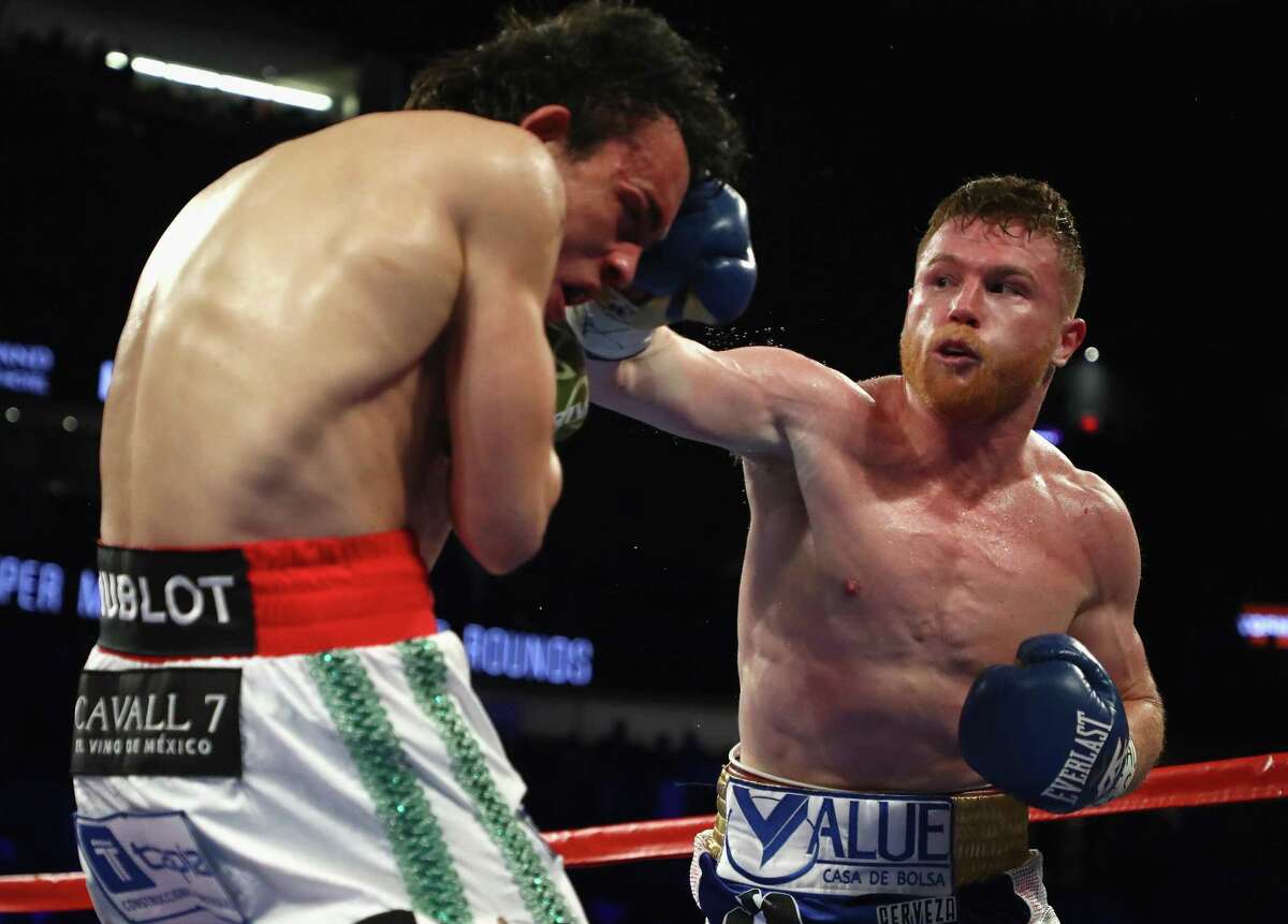Canelo Alvarez (right) punches Julio Cesar Chavez Jr. during their bout at T-Mobile Arena on May 6, 2017 in Las Vegas.