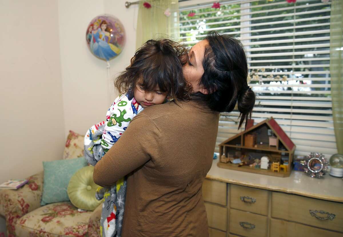Natalie Ruiz awakens her 3-year-old daughter Clara Blanchard in their University Village apartment in Albany, Calif. on Thursday, May 11, 2017. Ruiz will be be giving a commencement speech to her graduating UC Berkeley sociology department class on Sunday.