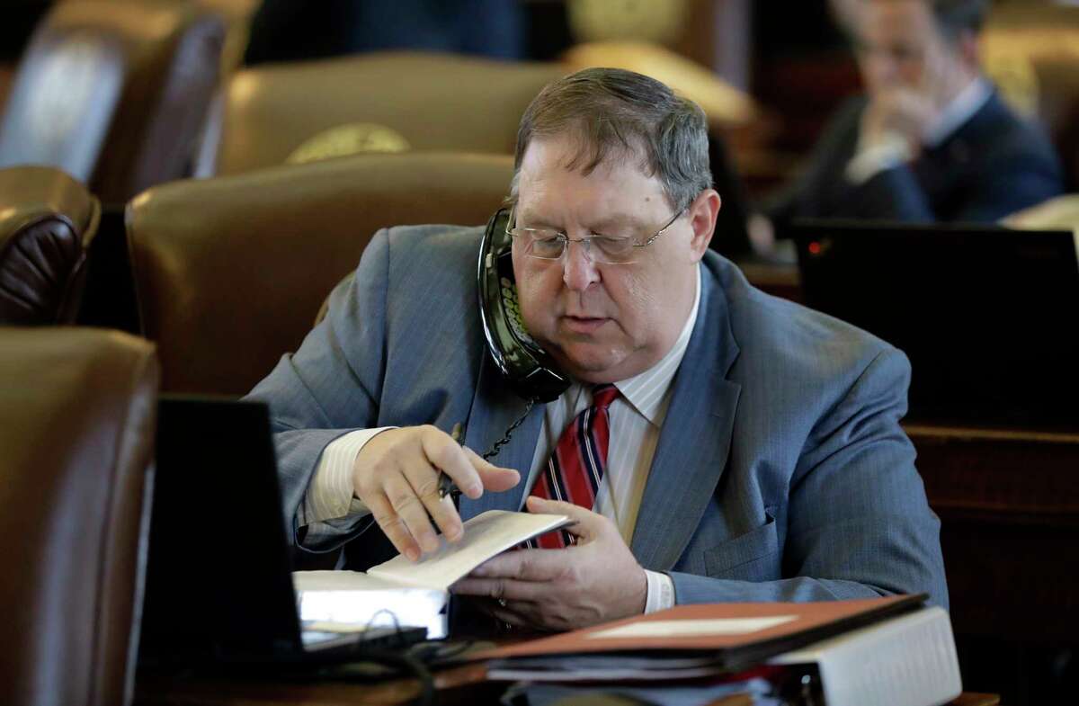 In this Wednesday, April 26, 2017 photo, Rep. Cecil Bell Jr., R-Magnolia works at his desk in the House Chamber at the Texas State Capitol, in Austin, Texas. Republicans control Congress and President Donald Trump has promised to drastically cut federal regulations, but for fiercely conservative Texas it may not be enough. (AP Photo/Eric Gay)