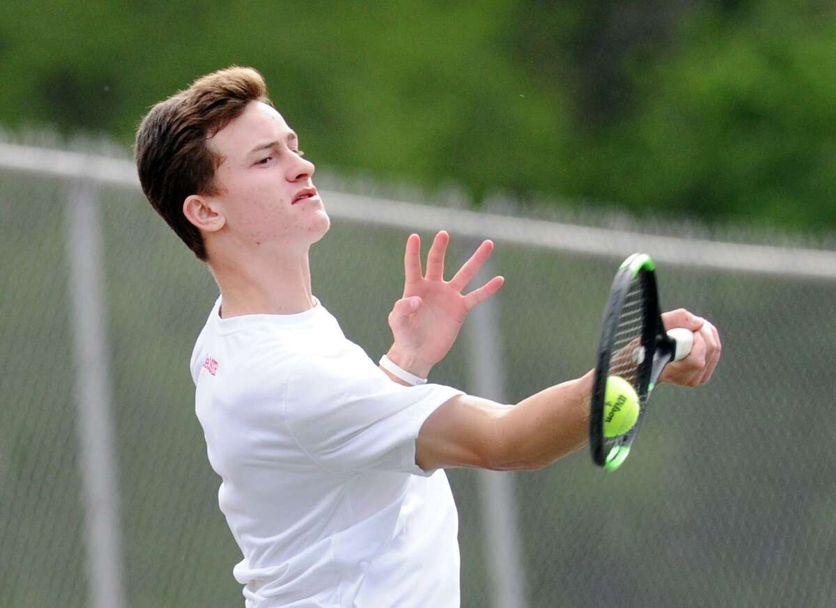 Henry DeCoster of Greenwich hits during his singles match against Fairfield Warde’s Robert Pavoni. DeCoster won 6-0, 6-1.