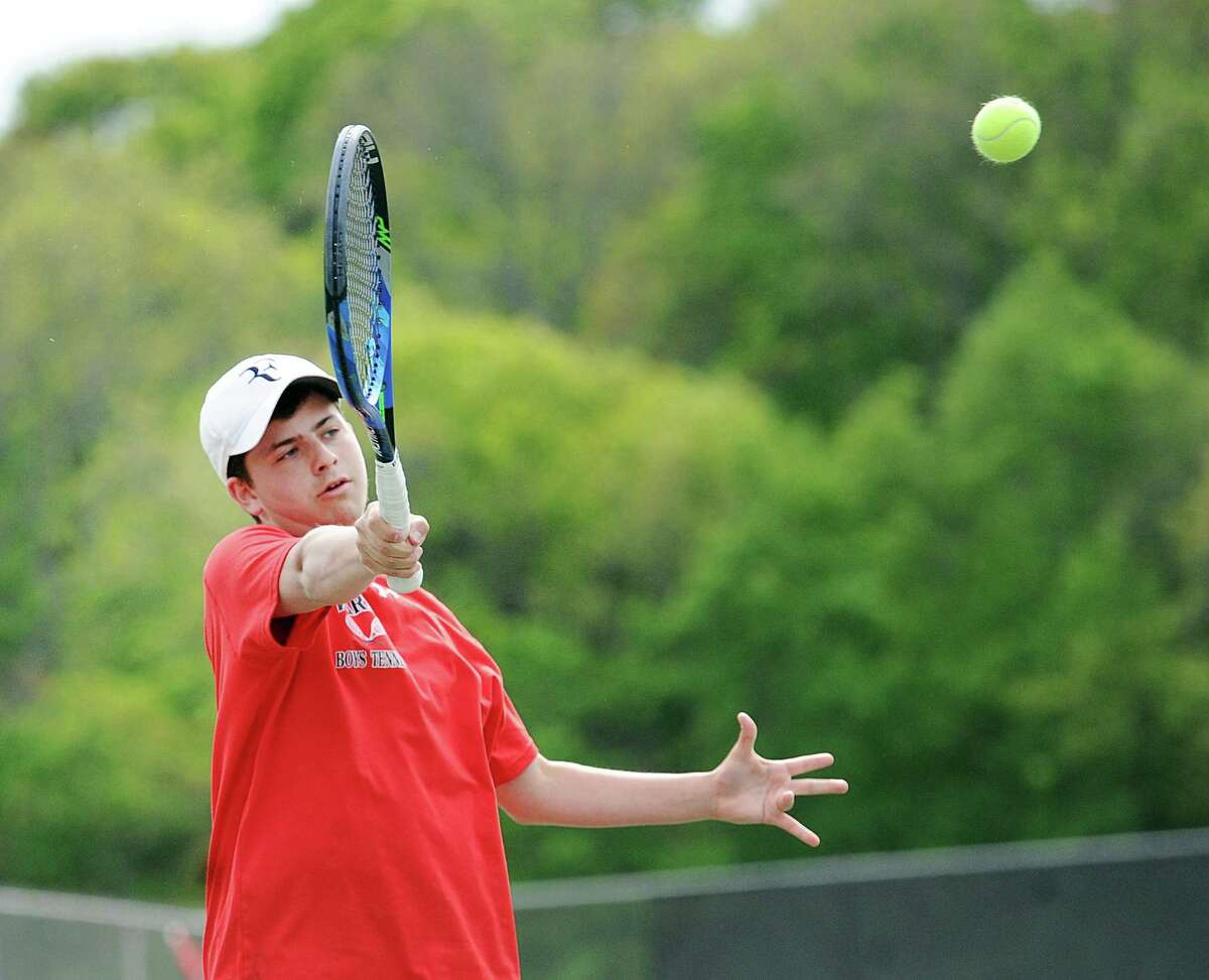 Kyle Rubin of Fairfield Warde High School hits against Eric Toub of Greenwich during the boys high school tennis match between Greenwich High School and Fairfield Warde High School at Greenwich, Conn., Thursday, May 11, 2017.