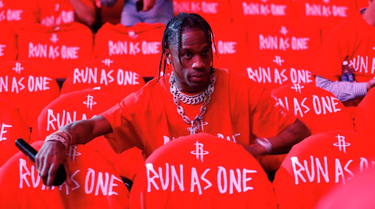 Travis Scott tries to get fans to put on their "Run as One" t-shirts before Game 6 of the second round of the Western Conference NBA playoffs at the Toyota Center, Thursday, May 11, 2017, in Houston.