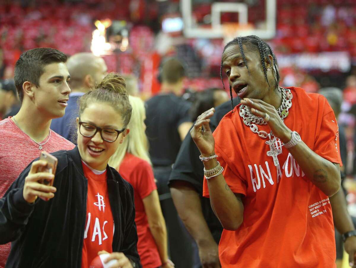 Travis Scott takes a picture with a fan before the first half of Game 6 of the Western Conference semi-final series between the Houston Rockets and San Antonio Spurs at Toyota Center, Thursday, May 11, 2017, in Houston.