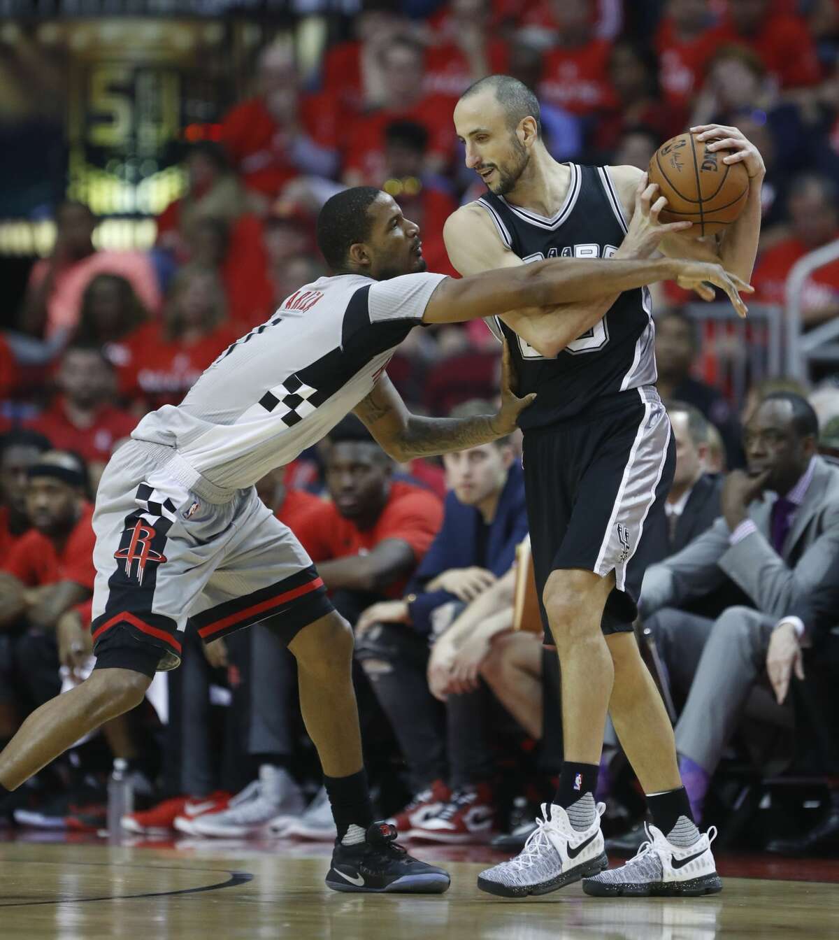 Houston Rockets forward Trevor Ariza (1) reaches for the ball held by San Antonio Spurs guard Manu Ginobili (20) during the first half of Game 6 of the second round of the Western Conference NBA playoffs at the Toyota Center, Thursday, May 11, 2017, in Houston. ( Karen Warren / Houston Chronicle )