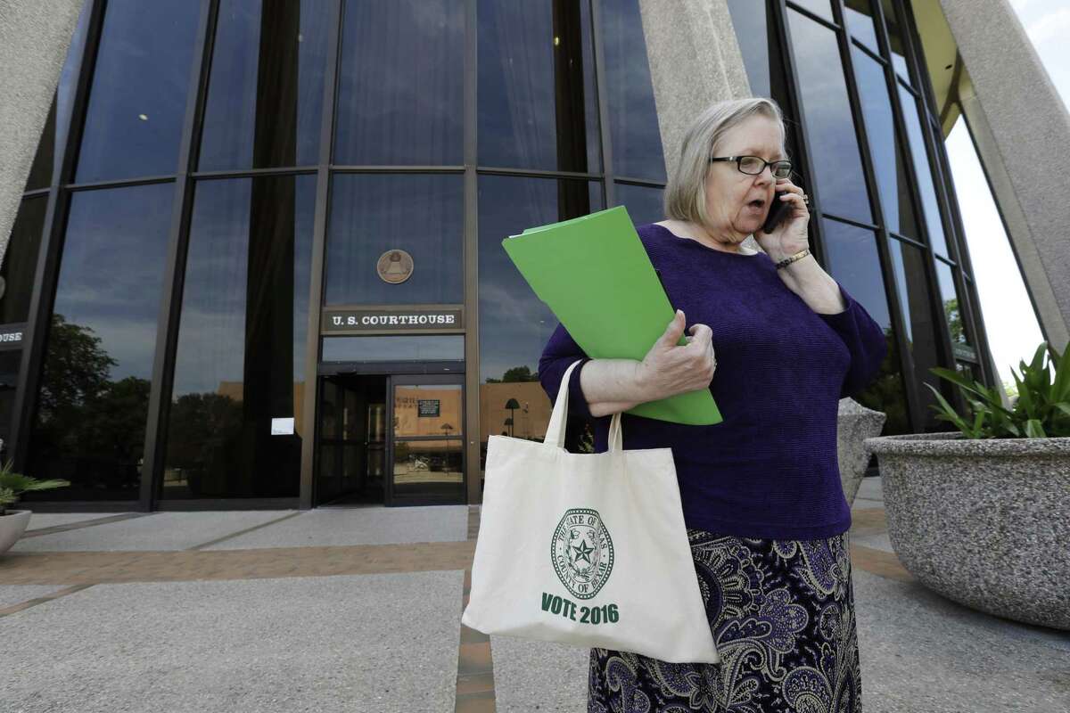 Jacquelyn Callanen, elections administrator for Bexar County, talks outside the U.S. Federal Courthouse, Thursday, April 27, 2017, in San Antonio. Three losses in federal court in barely a month over its voting laws have raised the stakes for Texas at a hearing before a three-judge panel. (AP Photo/Eric Gay)