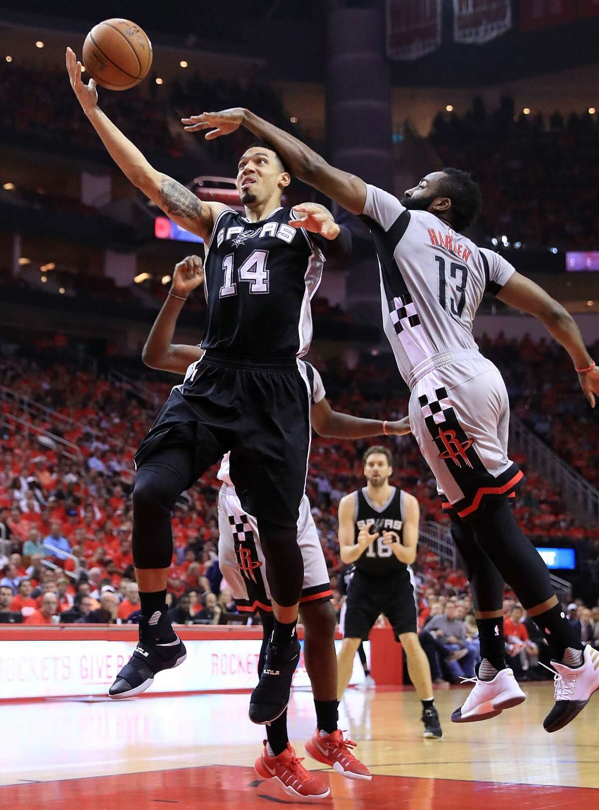 HOUSTON, TX - MAY 11: Danny Green #14 of the San Antonio Spurs drives between James Harden #13 and Clint Capela #15 of the Houston Rockets during Game Six of the NBA Western Conference Semi-Finals at Toyota Center on May 11, 2017 in Houston, Texas. NOTE TO USER: User expressly acknowledges and agrees that, by downloading and or using this photograph, User is consenting to the terms and conditions of the Getty Images License Agreement. (Photo by Ronald Martinez/Getty Images)