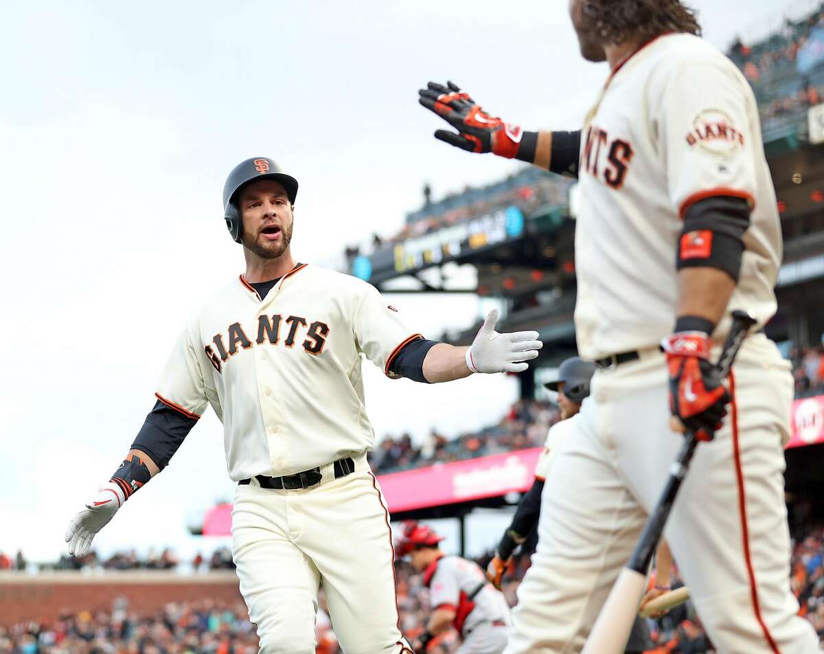 San Francisco Giants' Brandon Belt celebrates his solo home run with Brandon Crawford in 1st inning against Cincinnati Reds during MLB game at AT&T Park in San Francisco, Calif., on Thursday, May 11, 2017.