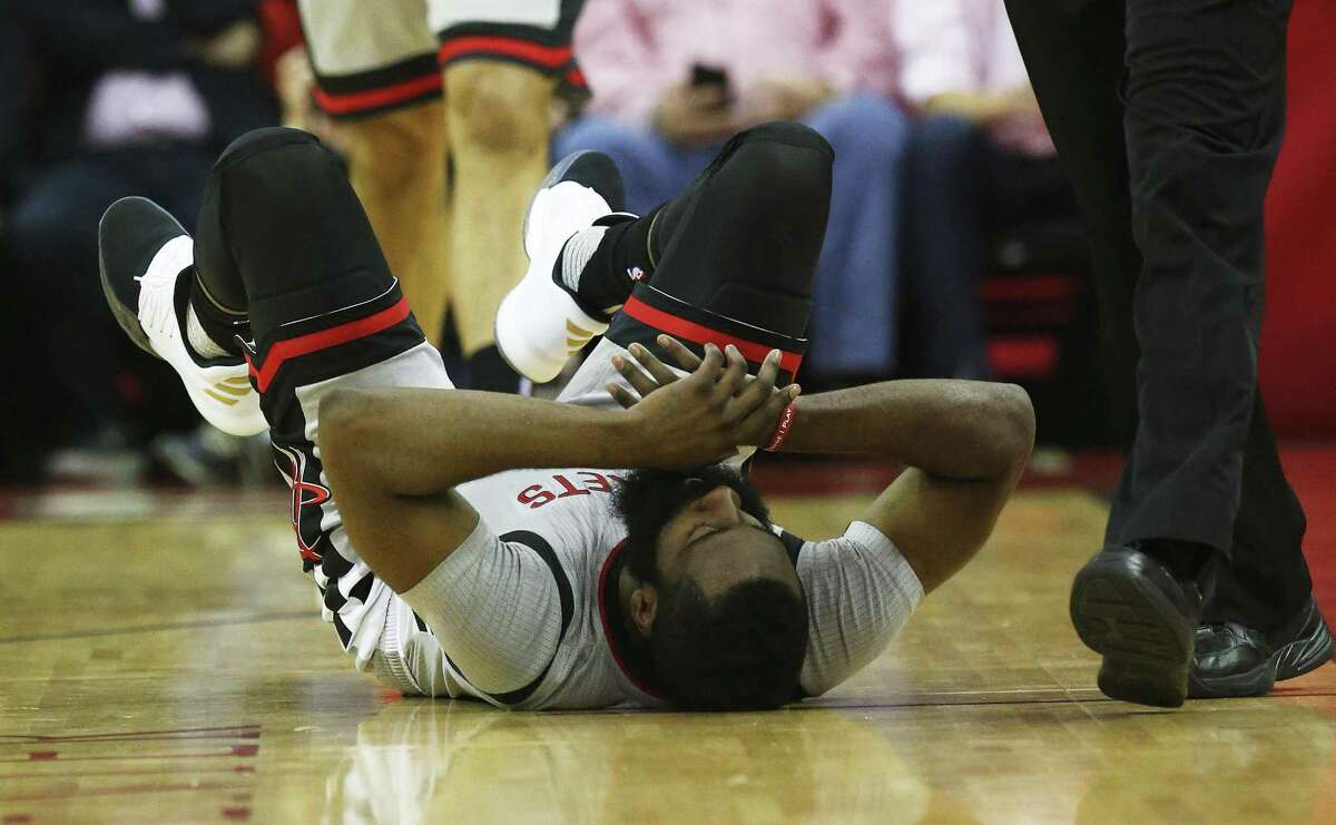 Rockets’ James Harden (13) falls to the floor after being fouled during Game 6 of the Western Conference semifinals against the Spurs at the Toyota Center on May 11, 2017.
