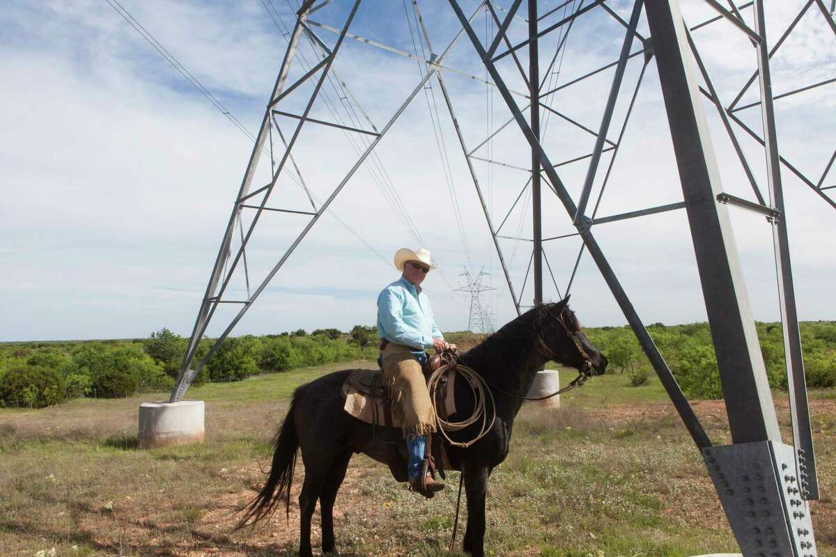 Rancher Richard Thorpe, owner of the Mesa T Ranch, poses underneath on of the towers installed on his land.