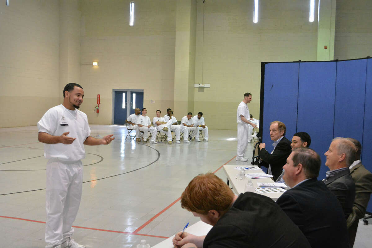 A prisoner enrolled in the Prison Entrepreneurship Program makes a pitch to a panel of judeges in preparation for a business plan competition at the Cleveland Correctional Center in Cleveland, Texas.