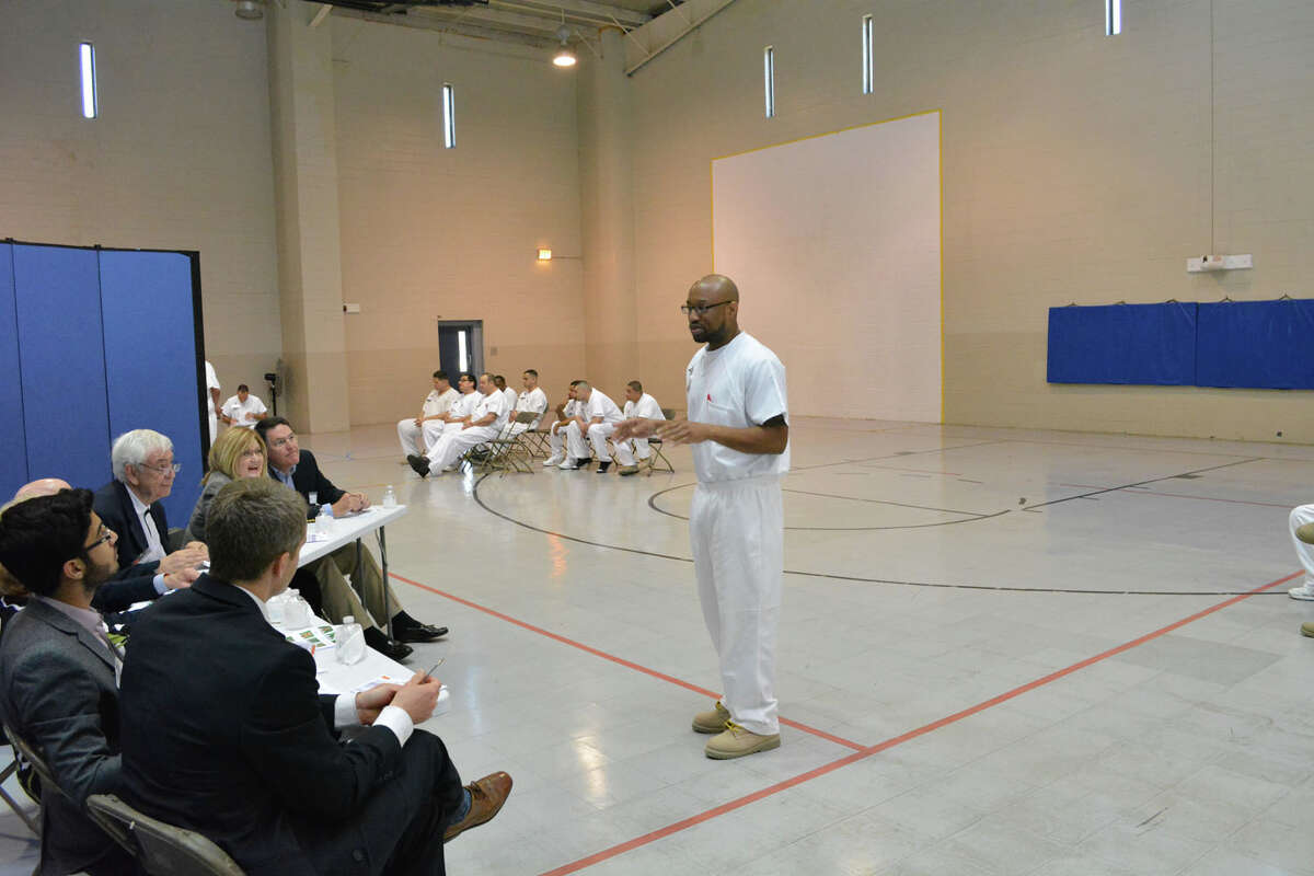 A prisoner enrolled in the Prison Entrepreneurship Program makes a pitch to a panel of judeges in preparation for a business plan competition at the Cleveland Correctional Center in Cleveland, Texas.