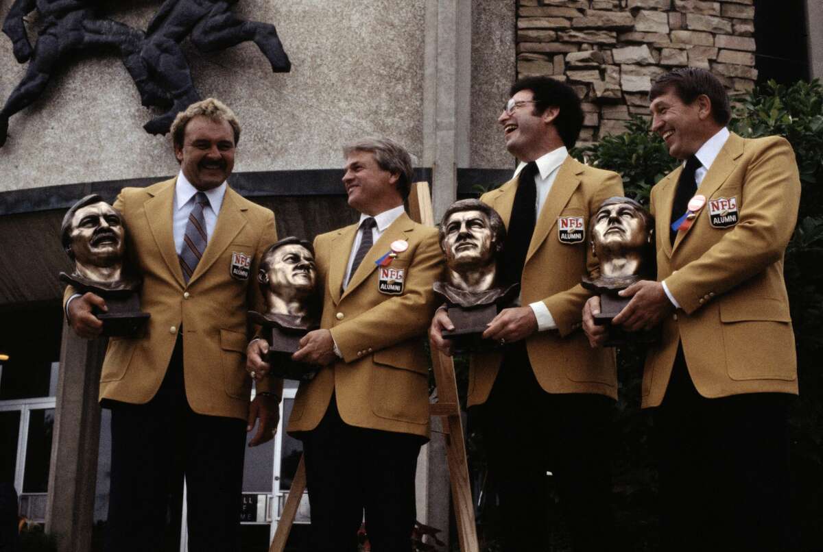 (Original Caption) Pro football Hall of Fame inductees pose on the steps of the Hall of Fame. From left to right are Dick Butkus, Yale Lary, Ron Mix and Johnny Unitas.