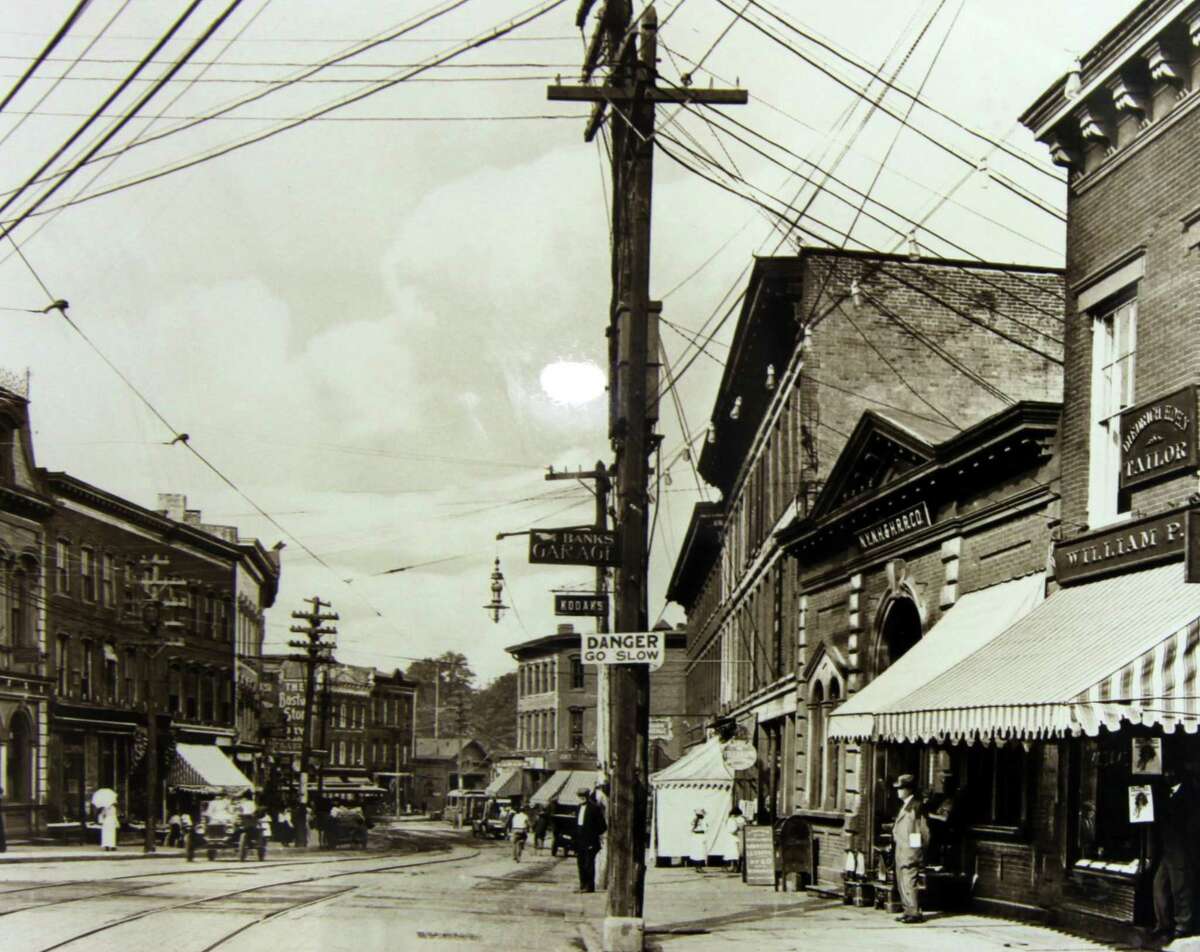 A photo showing the train station and historic buildings along Wall Street circa 1907 in downtown Norwalk.