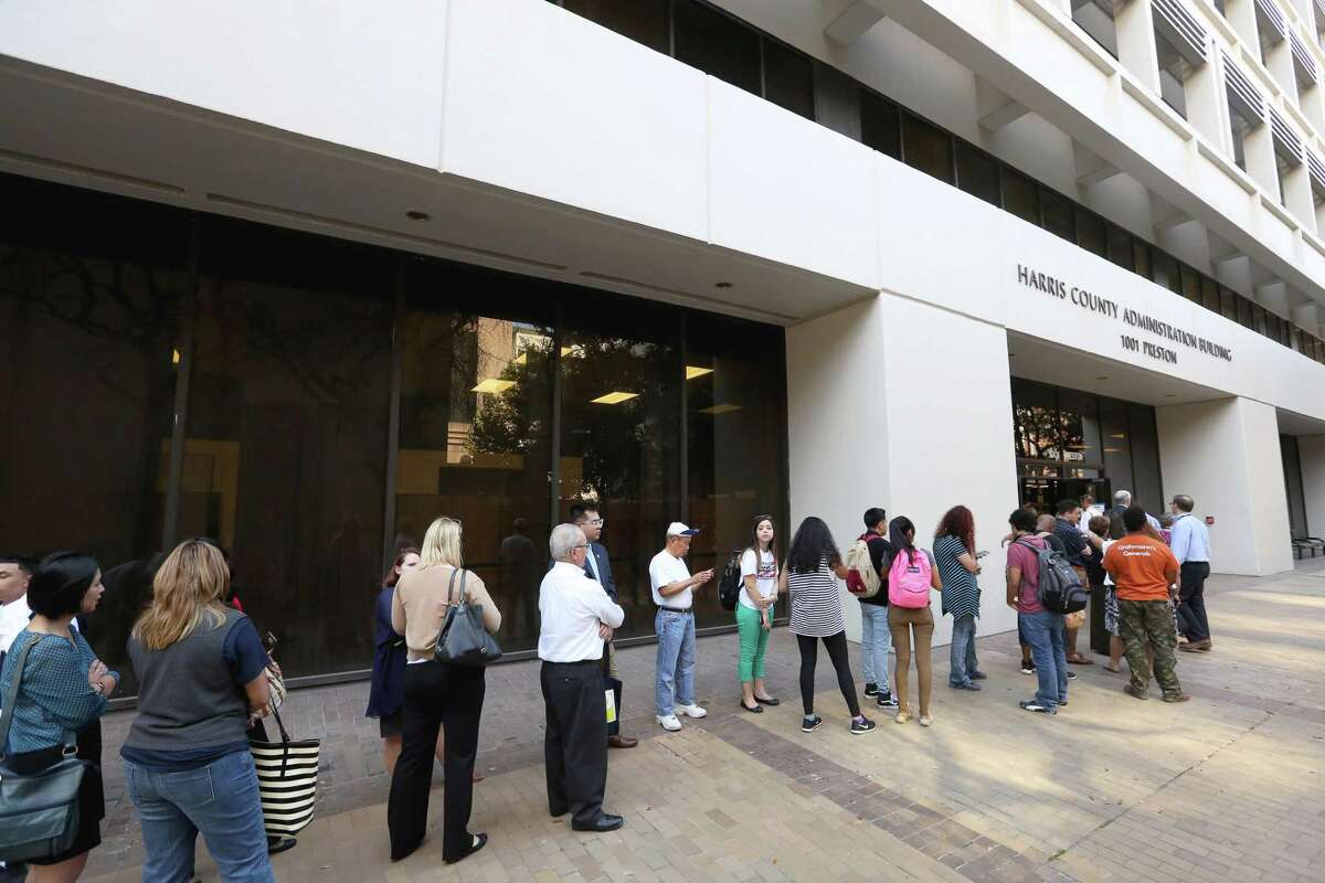 A long line of voters waiting to cast their votes for early voting outside of Harris County Tax Office Wednesday, Oct. 26 in Houston. A ProPublica report revealed shortcomings in the state oversight of the election last year because it failed to properly educate poll officials and voters on changes to the voter ID law.