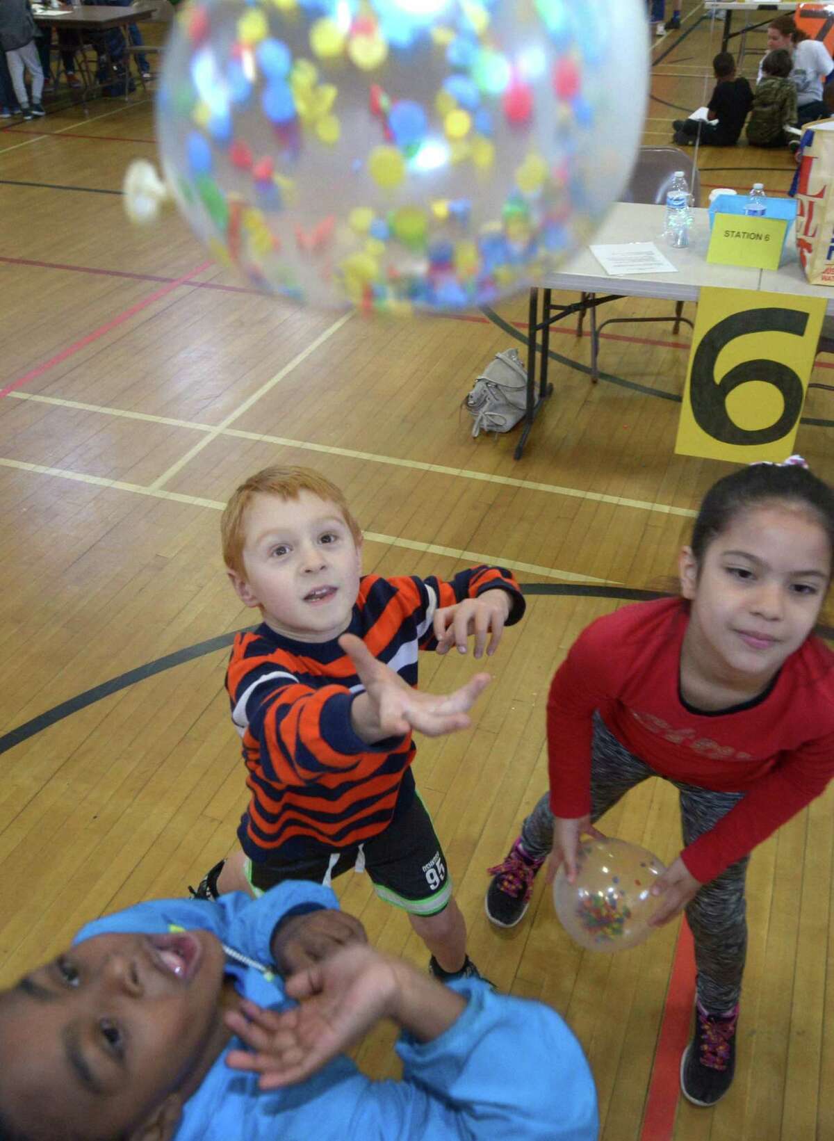 Jaevion Flade, Jake Courtney, and Jaliyah Navarro keep a ball off the ground at the Social Communication Station as Fox Run Elementary School hosts its inaugural ?“Celebrating Differences Day?” Friday, May 12, 2017, at the school in Norwalk, Conn. The day is designed to educate students on various disabilities and encourage them to celebrate everyone's differences.