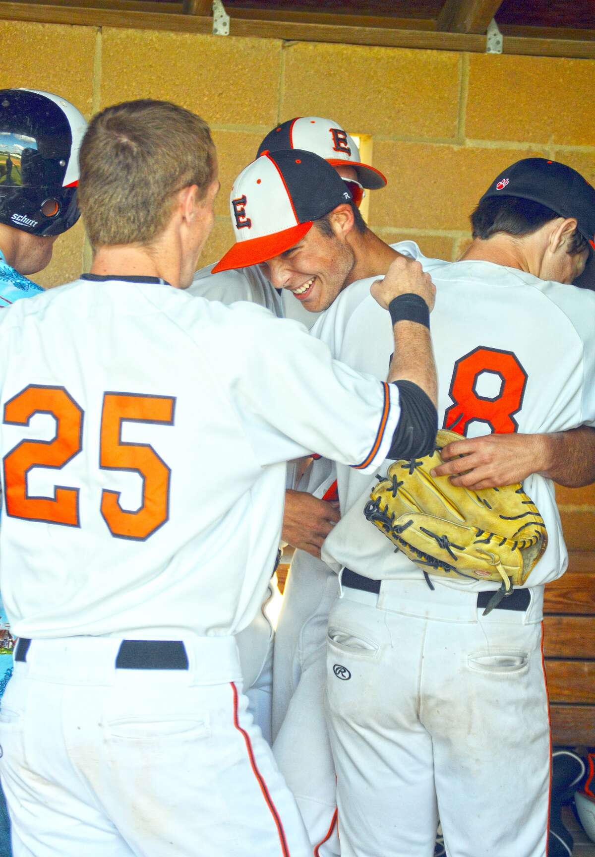 Edwardsville’s Joel Mueller is congratulated by his teammates after a base hit in the sixth inning.