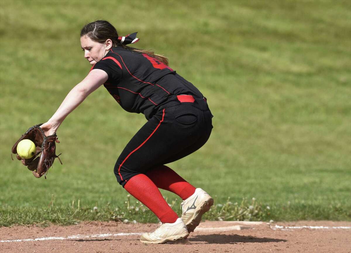 Pomperaug's Laurel Williams (4) back hands a ground ball hit down the thrird baseline in the girls softball game between New Fairfield and Pomperaug high schools on Friday, May 12, 2017, at Pomperaug High School, in Southbury, Conn.