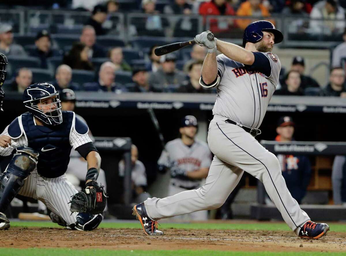 Houston Astros' Brian McCann, right, follows through on a three-run home run during the fourth inning of a baseball game as New York Yankees catcher Gary Sanchez watches, Friday, May 12, 2017, in New York. (AP Photo/Frank Franklin II)