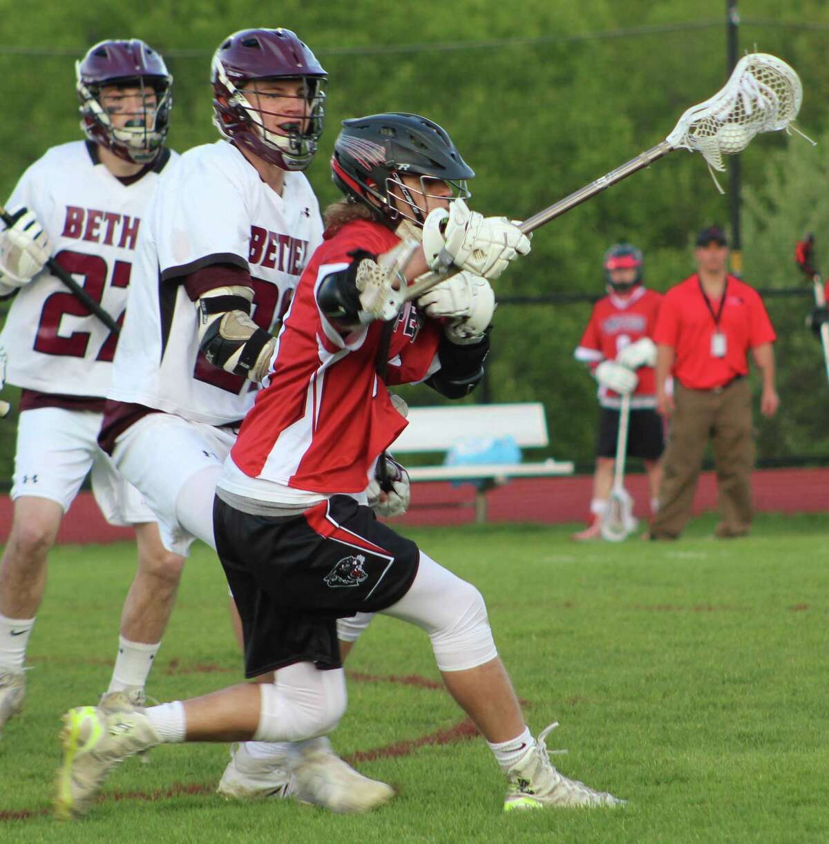 Pomperaug's Evan Cyganowski, right, looks for an opening as Bethel's Luke Newman, center, and Aiden Vizi defend during the boys lacrosse game at Bethel High School May 12, 2017.