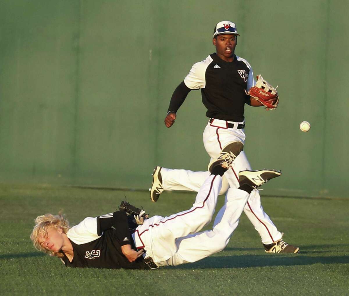 Churchill right fielder Hudson Head dives but misses a diving catch in the fourth inning as teammate Jordan Billups backs him up on the play against Clemens at Blossom Athletic Center on May 12, 2017.
