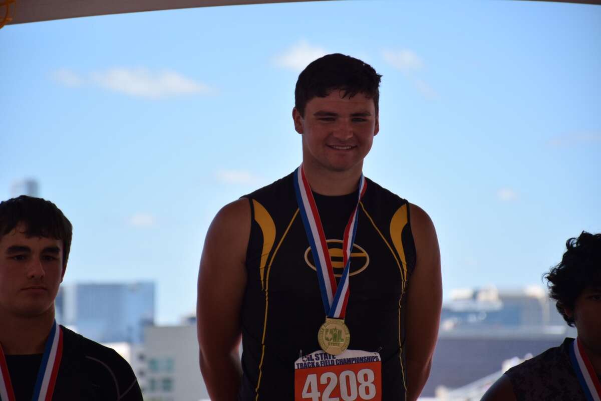 Grady's Jaylen Short stands on the medal stand after winning gold in the Boys Class 1A shot put Friday in Austin.