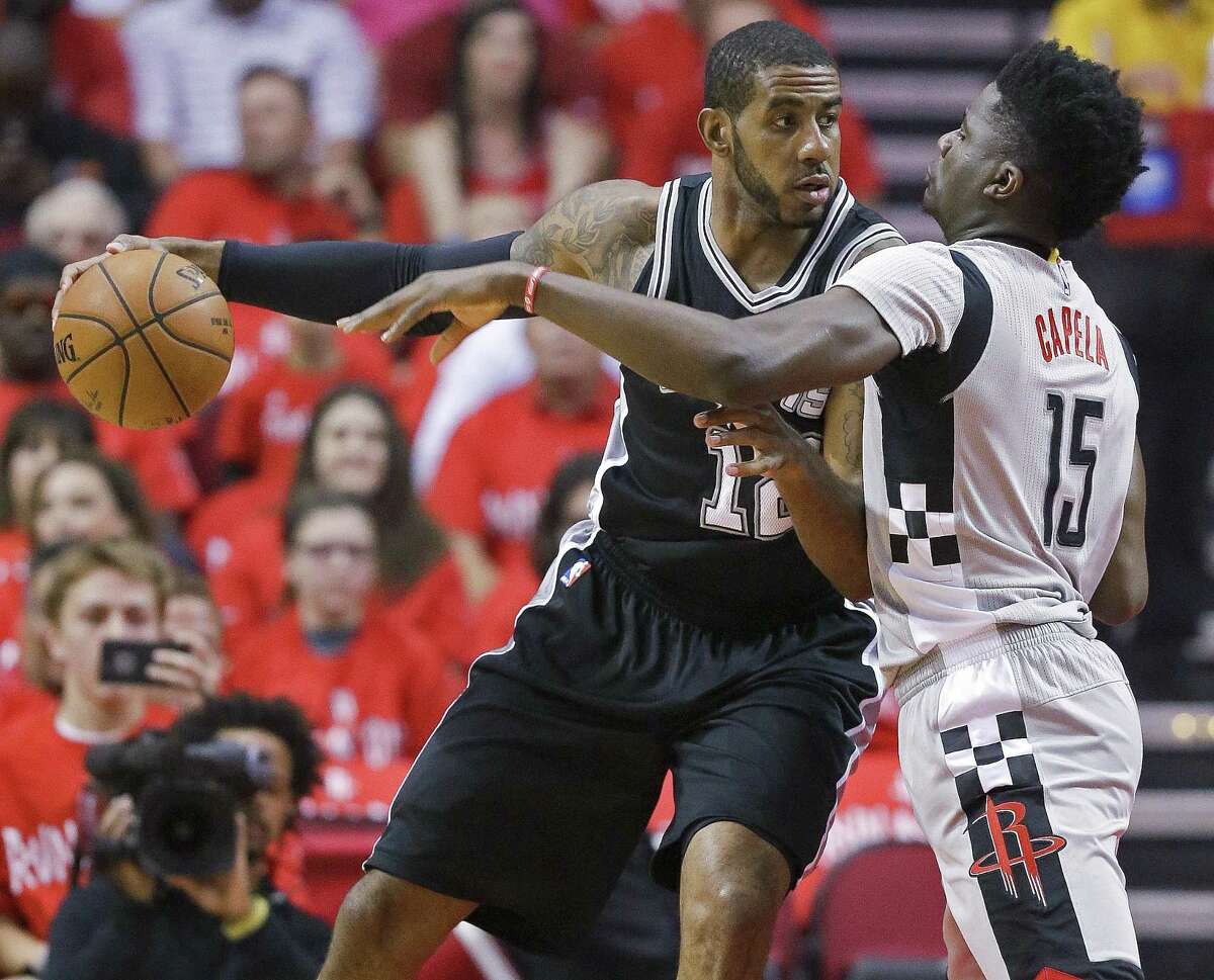 San Antonio Spurs forward LaMarcus Aldridge, left, dribbles as Houston Rockets center Clint Capela defends during the first half in Game 6 of an NBA basketball second-round playoff series, Thursday, May 11, 2017, in Houston. (AP Photo/Eric Christian Smith)