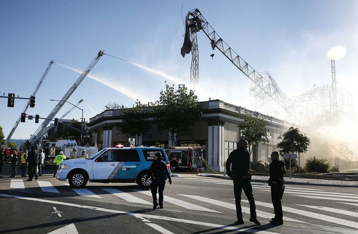 A construction crane buckled from intense heat after a 5-alarm fire destroys a condo development under construction on the 3800 block of San Pablo Avenue in Emeryville, Calif. on Saturday, May 13, 2017. A nearly identical fire destroyed the construction project at the same location in July 2016.