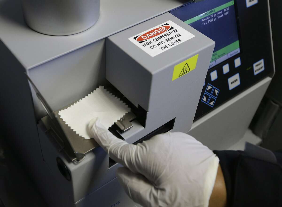 FILE -- In this May 20, 2015 file photo, Correctional Officer M. Jones, puts a test sample on an airport-style ion spectrometer that tests for illegal narcotics at Vacaville State Prison in Vacaville, Calif. California's $15 million bid to thwart prison drug smuggling has brought mixed results, researches found. Drug use in the three prisons with the most extensive programs dropped by nearly a quarter after corrections officials increased the use of airport-style scanners, surveillance cameras, urine tests and drug-sniffing dogs, but there was little effect at eight other prisons where the safeguards were used less frequently. (AP Photo/Rich Pedroncelli, file)