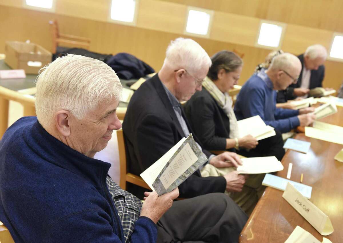 Jack Cuff, left, and others read a passage in Leo Tolstoy's "The Death of Ivan Ilych" at the Great Books discussion group at Greenwich Library in Greenwich.