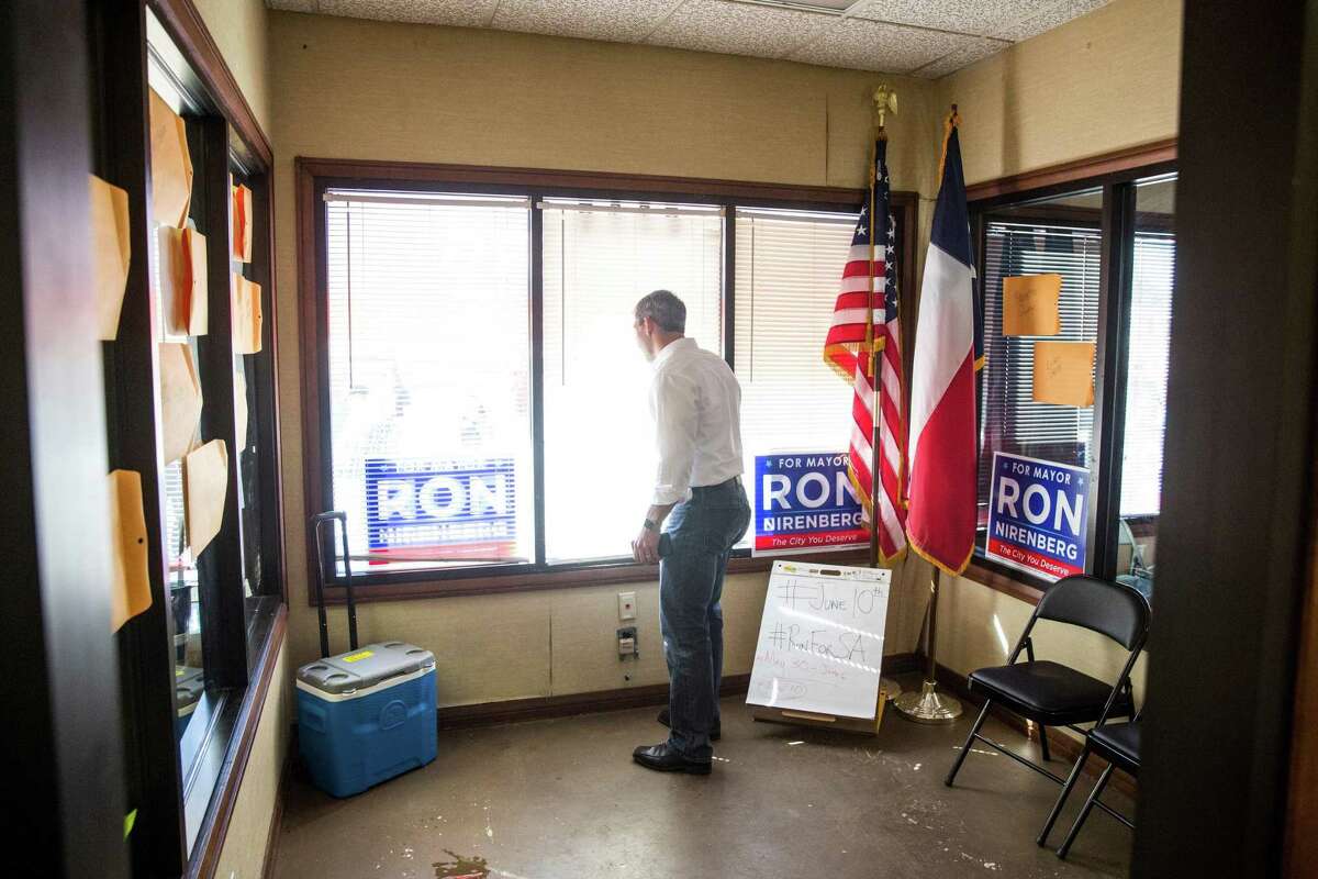 Mayoral candidate Ron Nirenberg talks on the phone with his son while looking out a window at his campaign headquarters in San Antonio, Texas on May 13, 2017. Ray Whitehouse / for the San Antonio Express-News