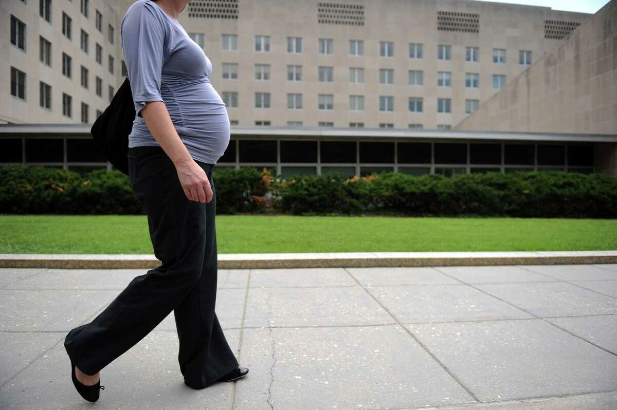 (FILES) This file photo taken on August 5, 2010 shows a pregnant woman walking outside the State Department in Washington, DC. / AFP PHOTO / Timothy SLOANTIMOTHY SLOAN/AFP/Getty Images