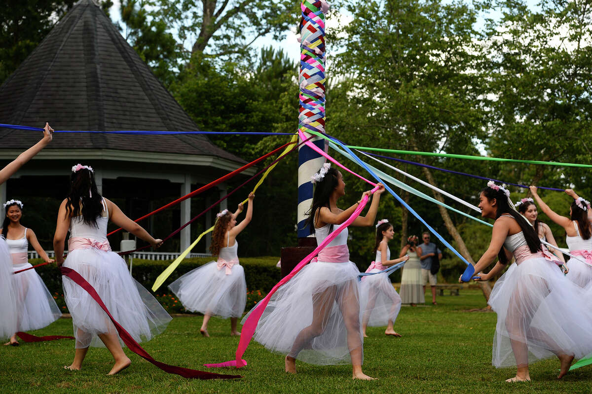 Dancers with the Bonnie Cokinos School of Dance dance around the pole during the Maypole Festival at Tyrrell Park on Saturday. The annual festival is symbolic of new beginnings and held in memory of Paula "Torchy" Salter, who passed away in 2010. Photo taken Saturday 5/13/17 Ryan Pelham/The Enterprise