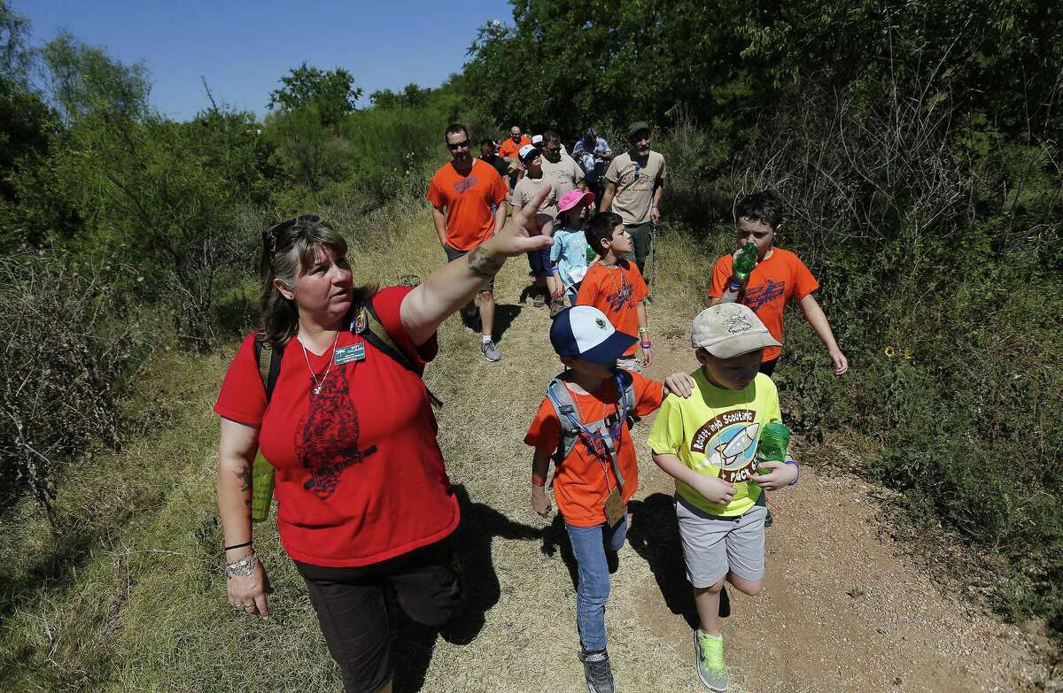 Texas Master Naturalist Patty Hallmark (left) takes a group on a nature tour as the Mitchell Lake Audubon Center holds its Migratory Bird Festival on Saturday, May 13, 2017. At the festival, guests saw how birds were banded in order to keep track of their migratory patterns, went on a nature trail tour and other presentations about birds. There were also crafts and games to entertain the younger crowd. Since 2001 when the Audubon Center was established at Mitchell Lake, the mission of the center is focused on educational programs along with preserving open space to protect wildlife and habitat. With about 1,200 acres of property, MLAC has become a sanctuary for hundreds of migrating birds. (Kin Man Hui/San Antonio Express-News)